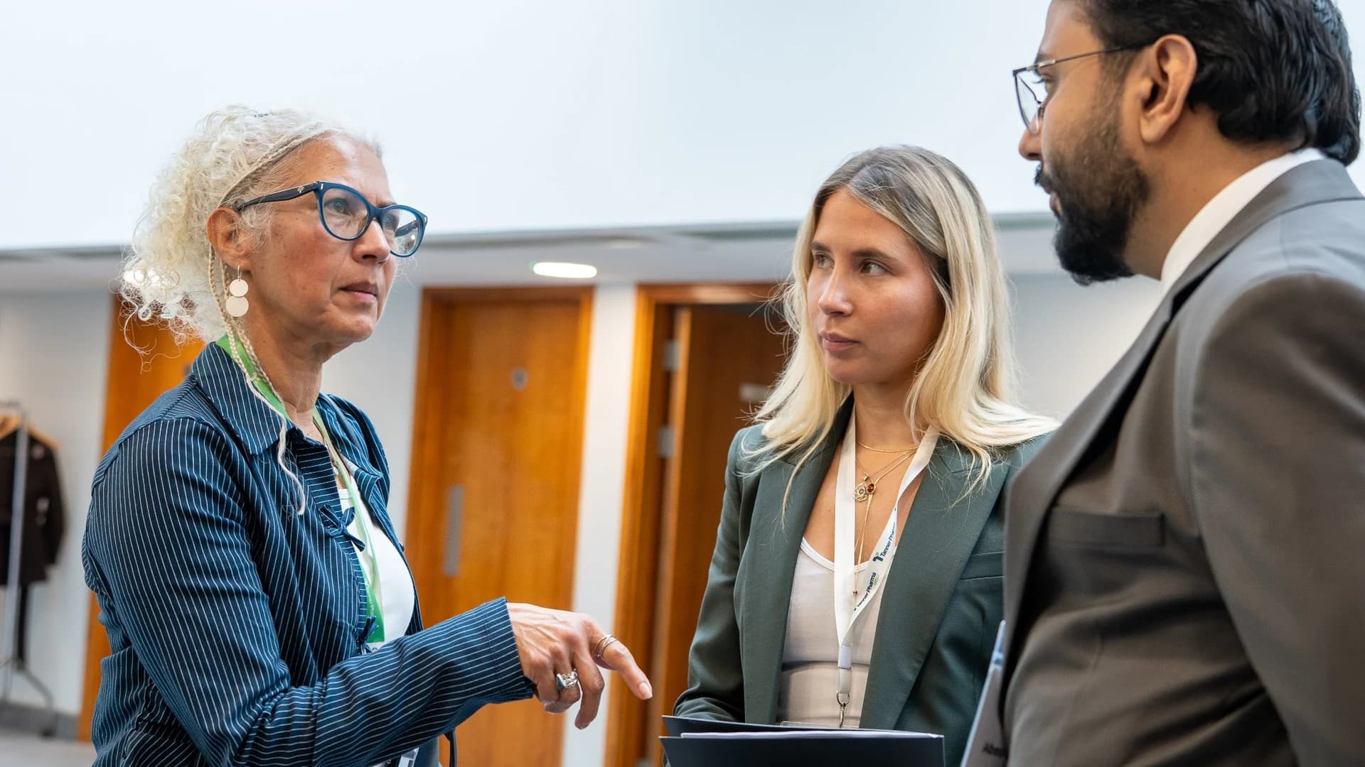 Three delegates in conversation between sessions