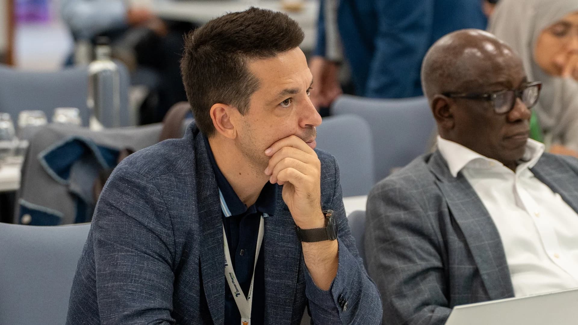 Two delegates concentrating on a session